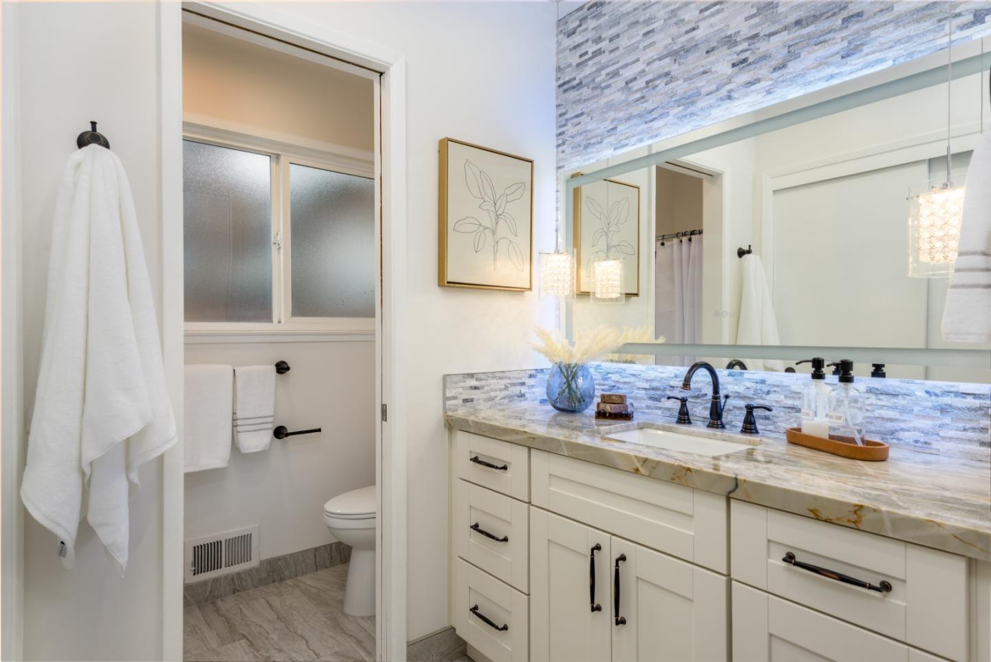 1420 South Mary Avenue Sunnyvale, CA 94087 - Photo 15 of 24 a bathroom with a granite countertop sink and a mirror
