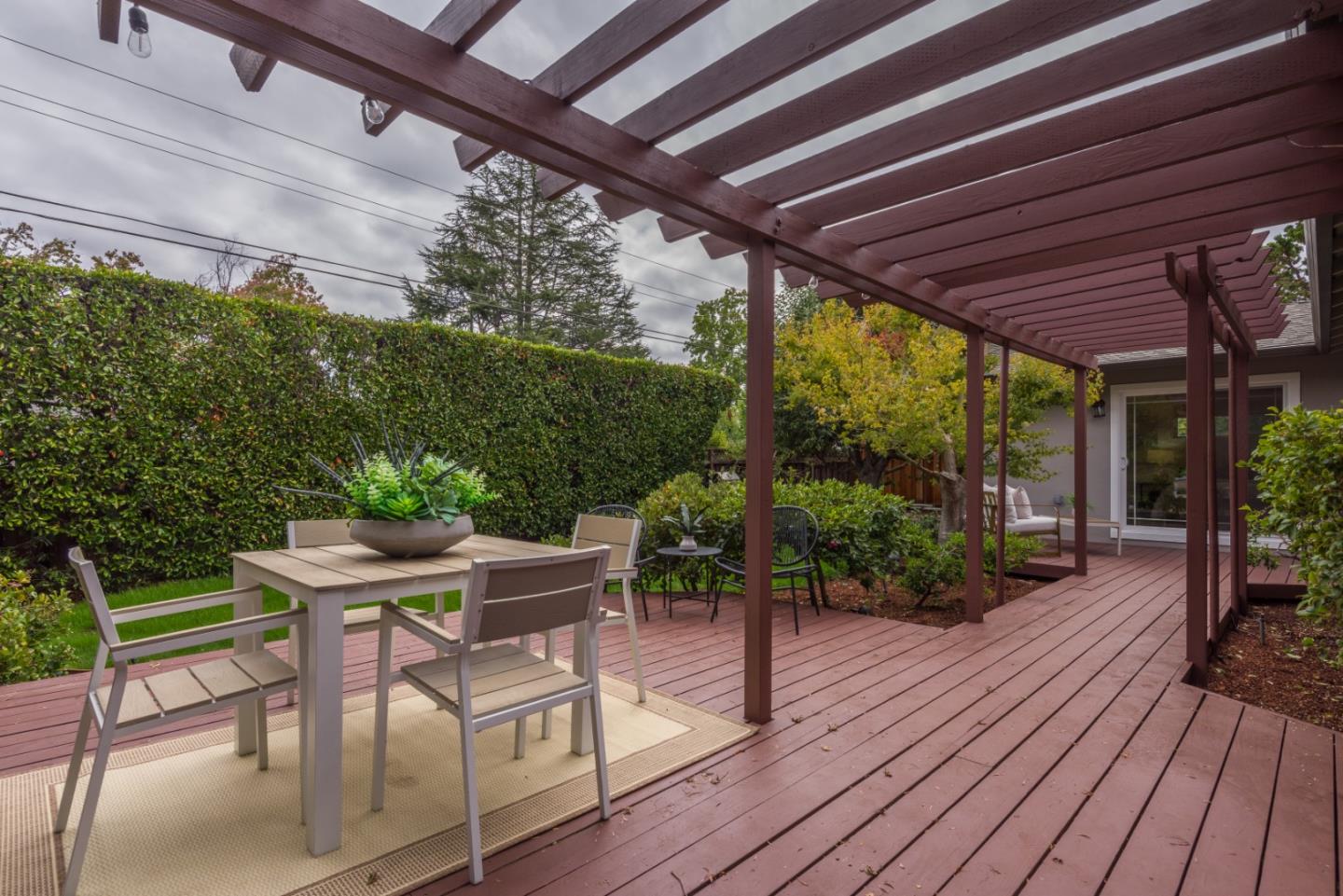 1420 South Mary Avenue Sunnyvale, CA 94087 - Photo 20 of 24 a view of a patio with table and chairs potted plants with wooden floor and floor to ceiling window