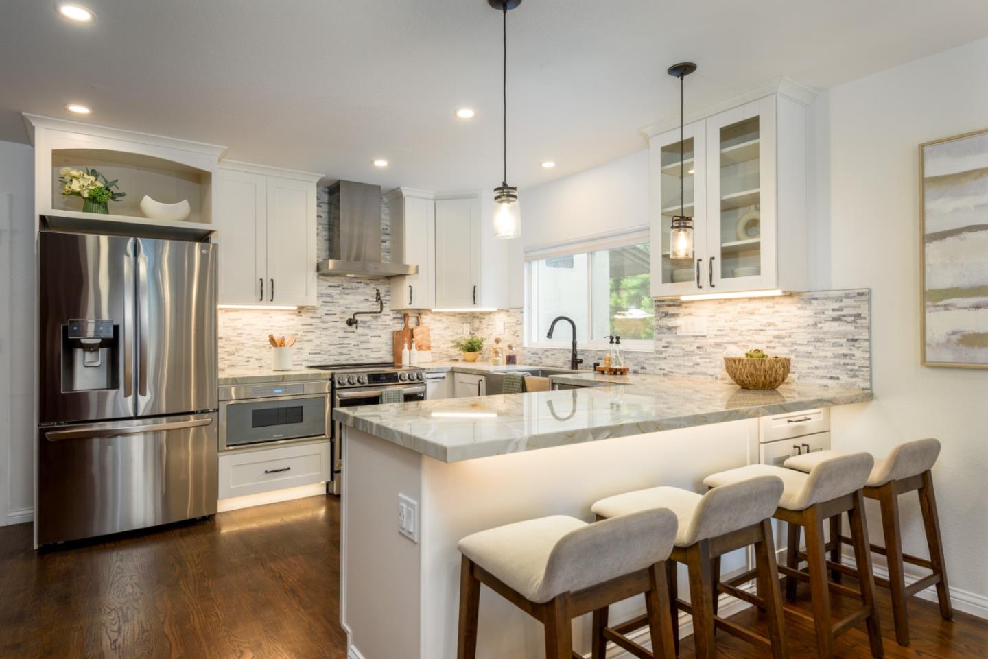 1420 South Mary Avenue Sunnyvale, CA 94087 - Photo 7 of 24 a kitchen with stainless steel appliances granite countertop a sink a stove a refrigerator and island with wooden floor