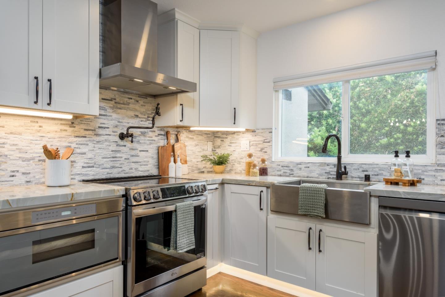 1420 South Mary Avenue Sunnyvale, CA 94087 - Photo 8 of 24 a kitchen with stainless steel appliances a stove sink and cabinets