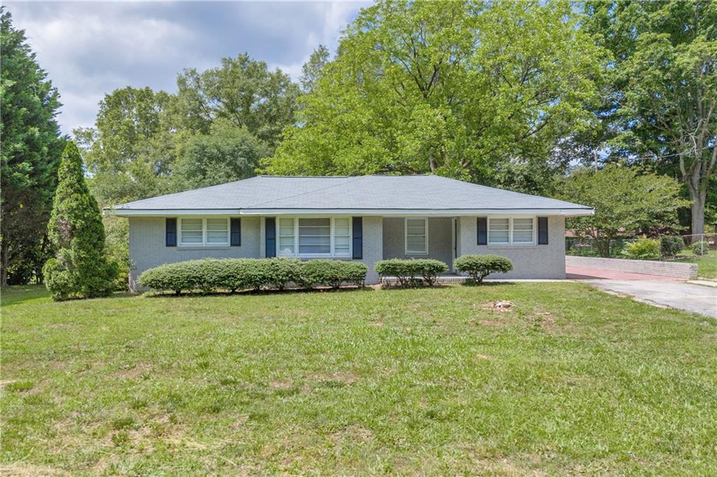 1283 Mount Paran Church Road Monroe, GA 30655 - Photo 1 of 1 a front view of a house with a yard