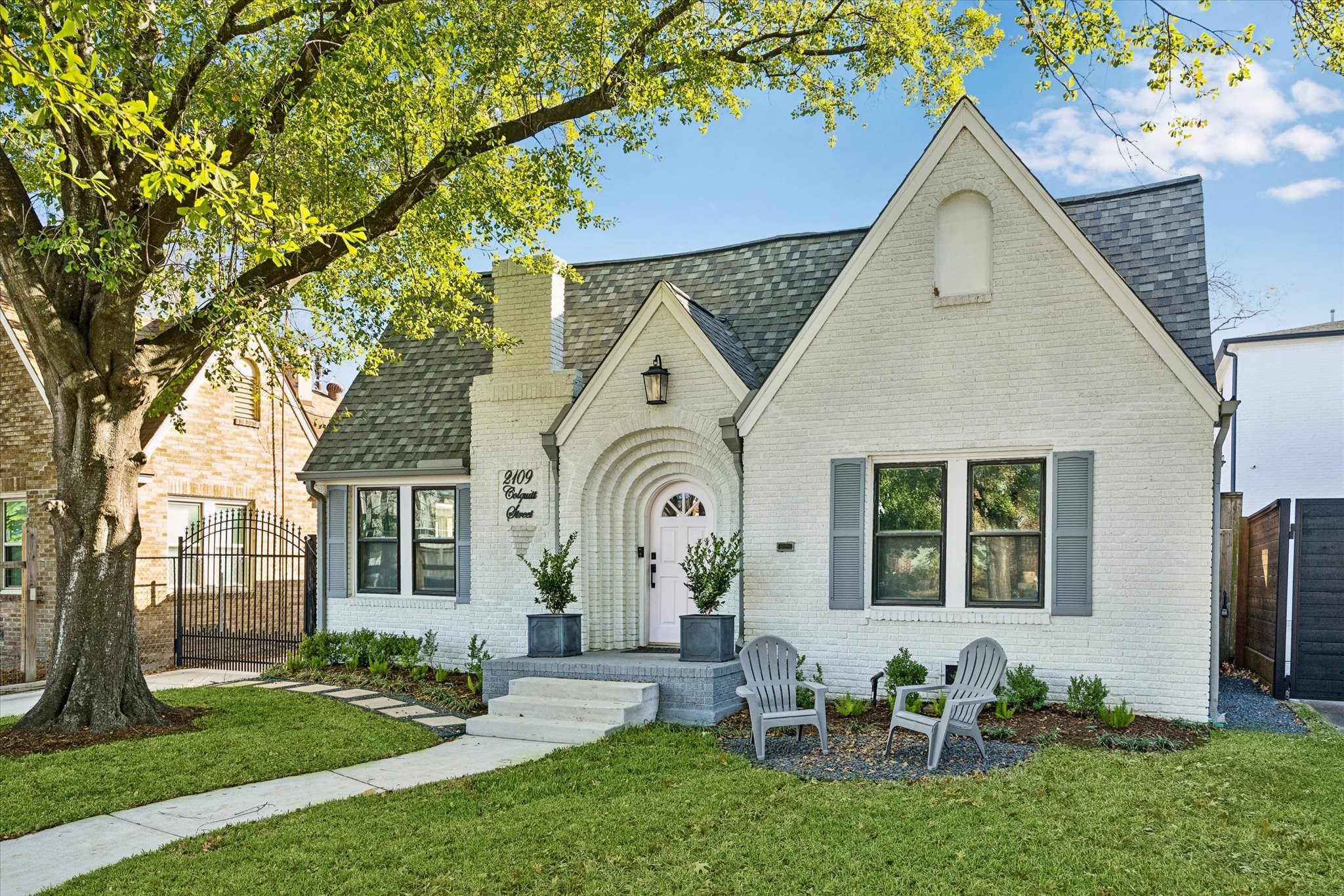 2109 Colquitt Street Houston, TX 77098 - Photo 28 of 28 The charming front elevation showcases classic brick architecture, steep rooflines, and mature landscaping.