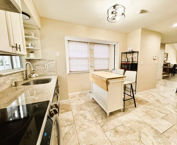 a very nice looking kitchen with a large window