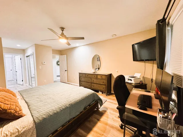 a bedroom with a bed a flat screen tv and a couch