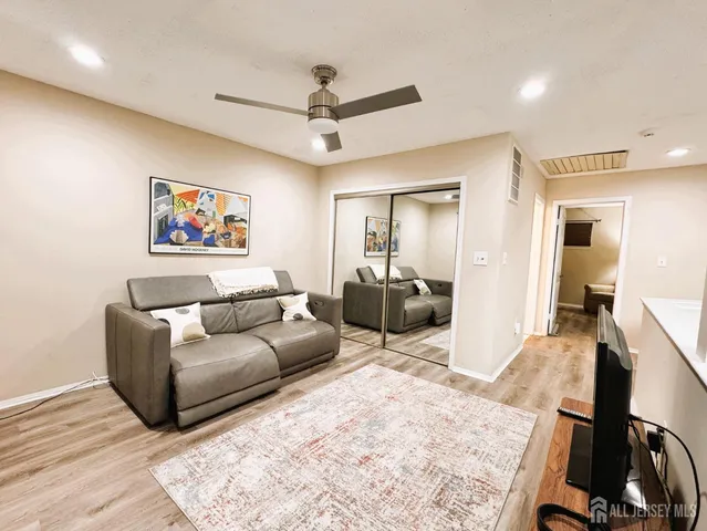 a living room with furniture and a wooden floor