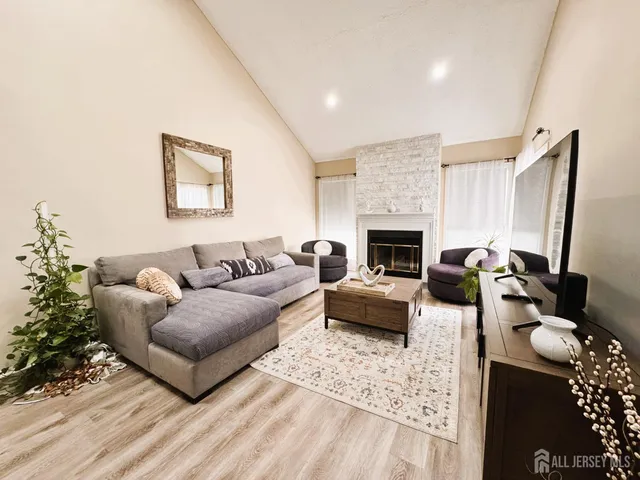 a living room with furniture and a fireplace