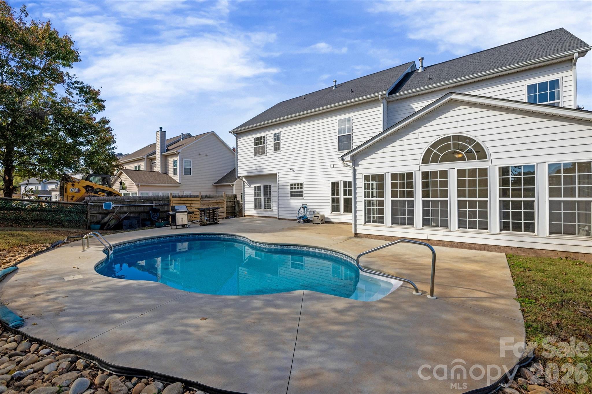 a view of a house with swimming pool and sitting area
