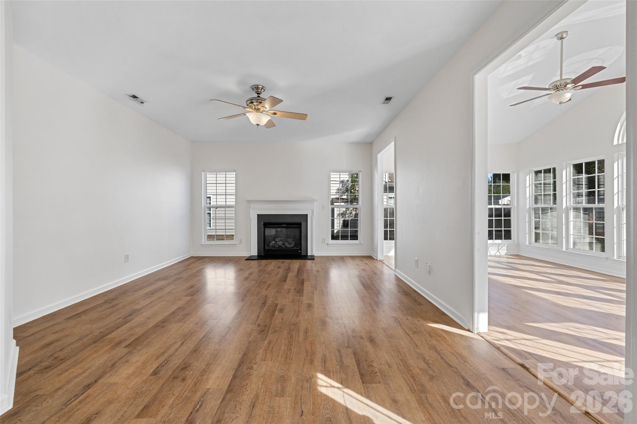 813 Circle Trace Road Monroe, NC 28110 - Photo 20 of 37 wooden floor fireplace and windows in an empty room