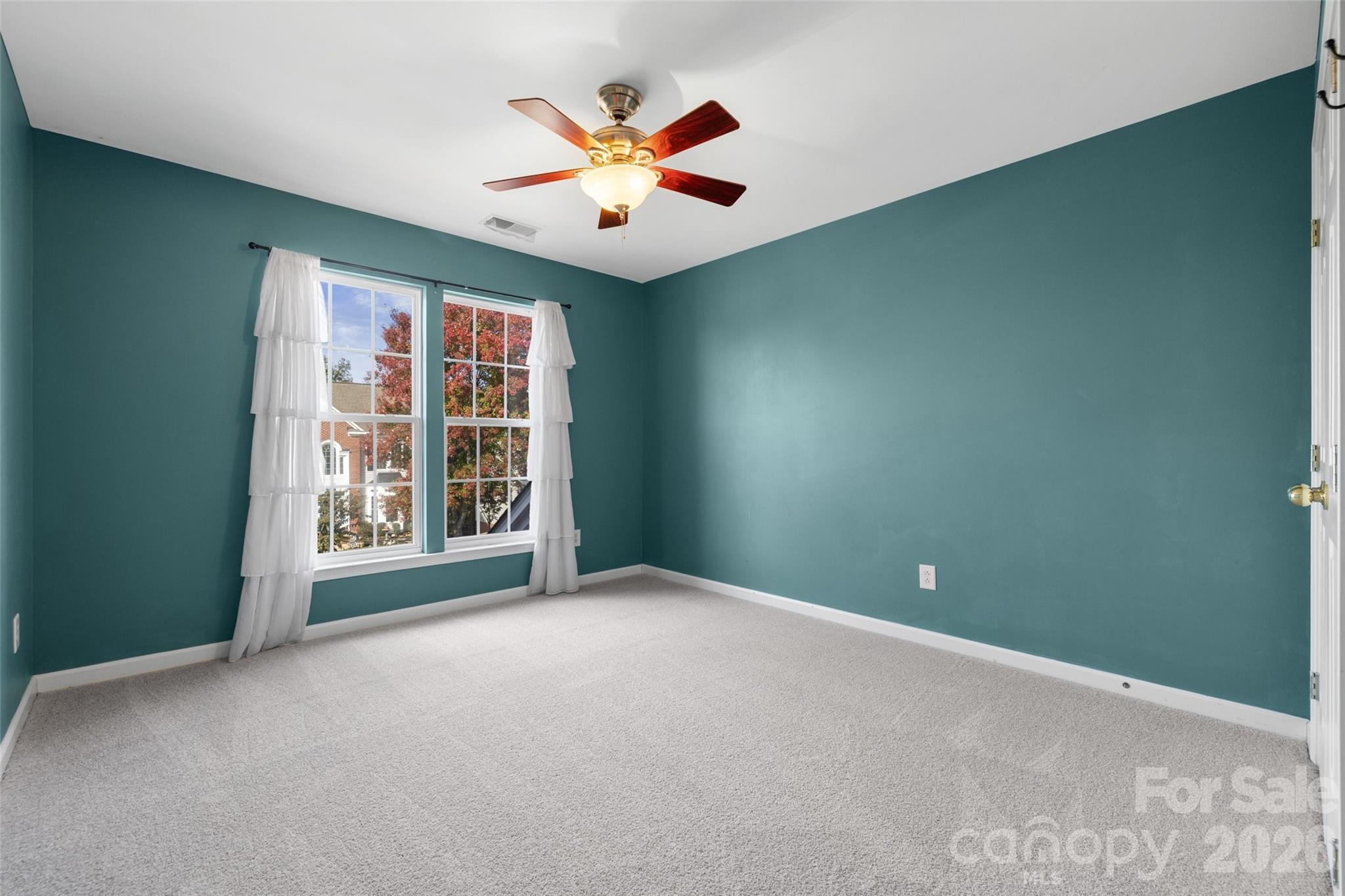 813 Circle Trace Road Monroe, NC 28110 - Photo 27 of 37 an empty room with windows and chandelier fan