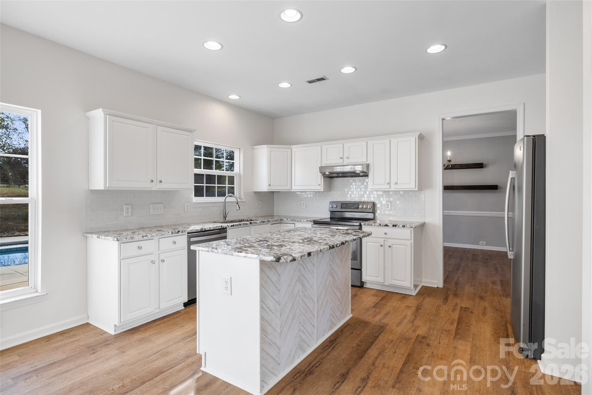 813 Circle Trace Road Monroe, NC 28110 - Photo 7 of 37 a kitchen with stainless steel appliances granite countertop a stove and a refrigerator