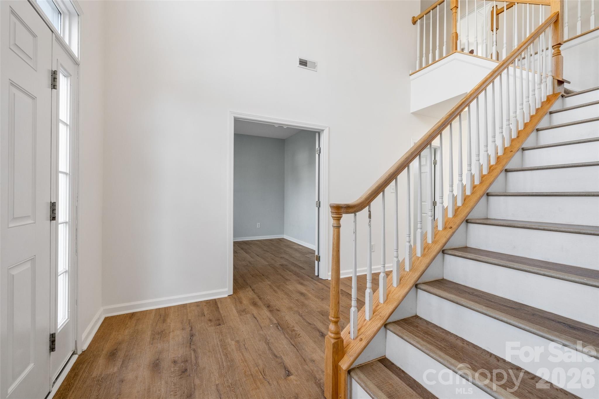 813 Circle Trace Road Monroe, NC 28110 - Photo 10 of 37 a view of staircase with wooden floor and a rug