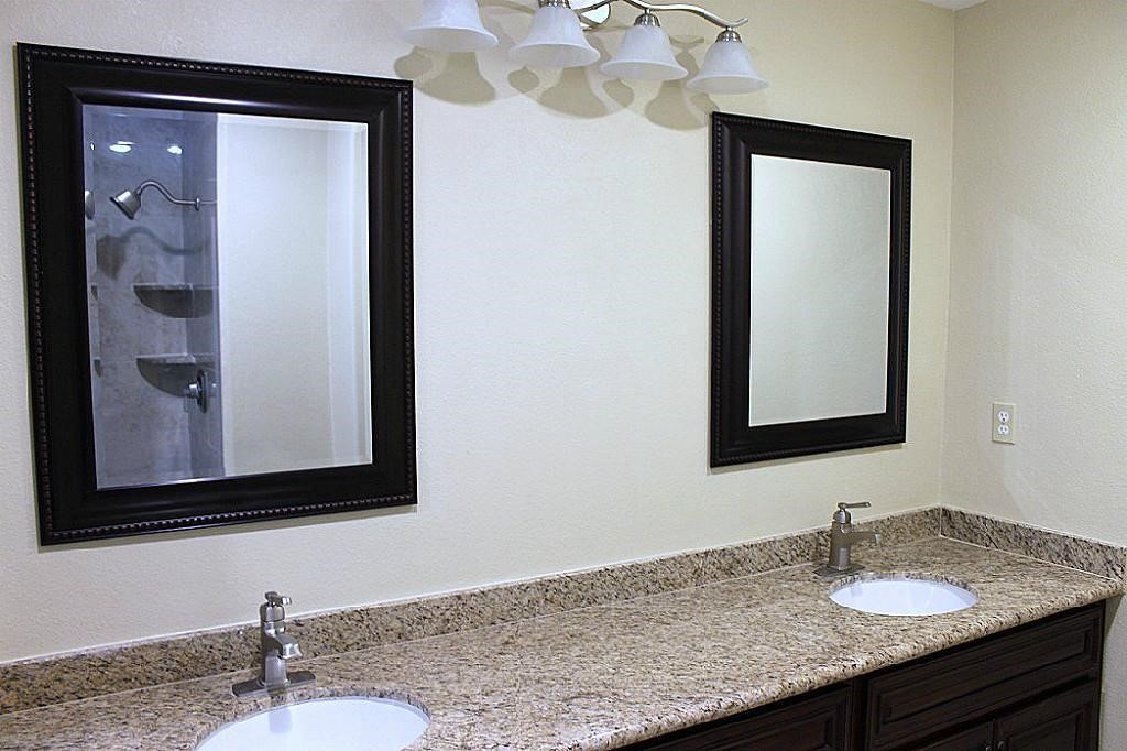5738 Willowbend Boulevard Houston, TX 77096 - Photo 20 of 28 a bathroom with a granite countertop sink and a mirror