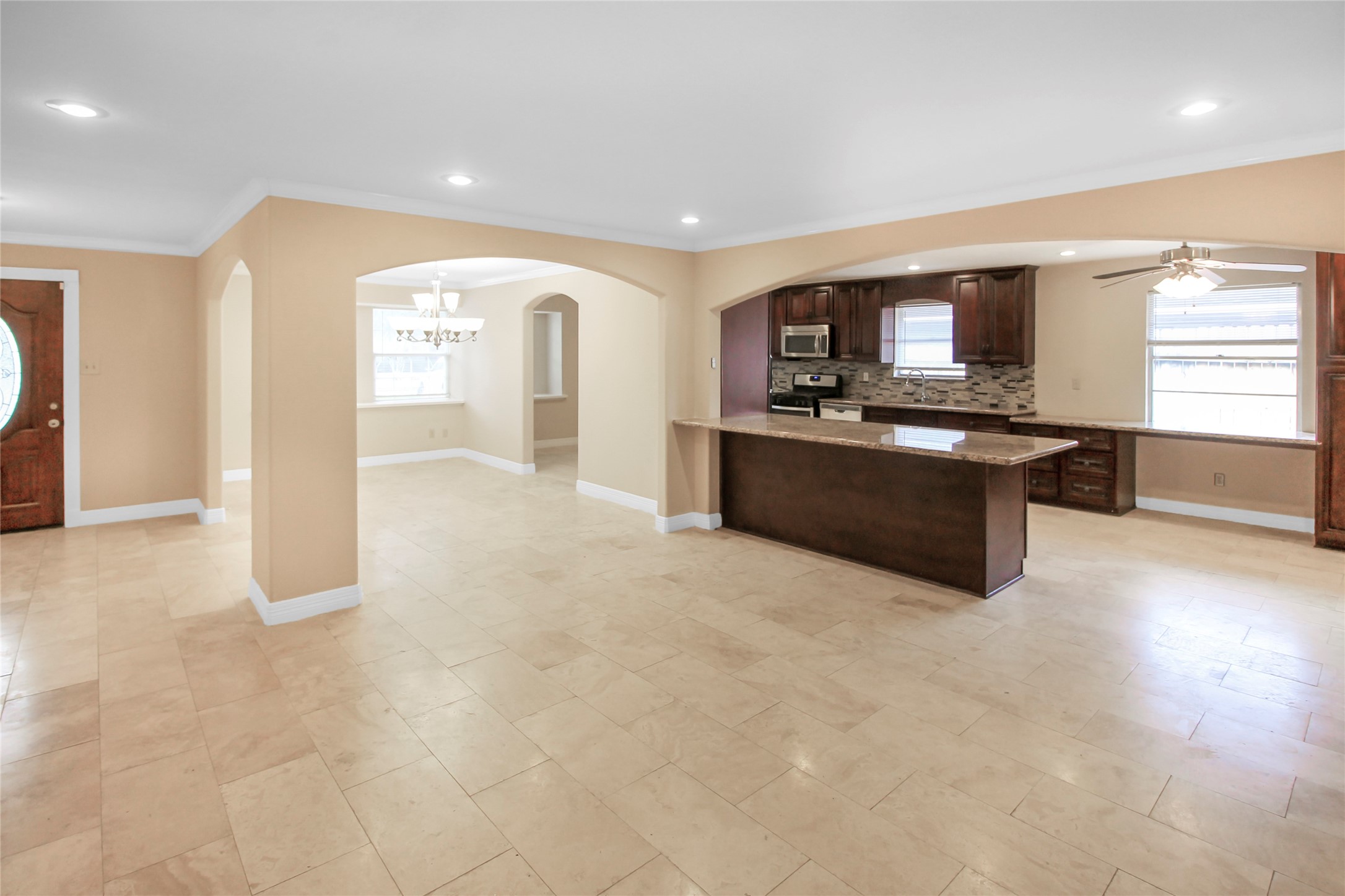 5738 Willowbend Boulevard Houston, TX 77096 - Photo 4 of 28 a large kitchen with stainless steel appliances granite countertop a stove and a sink