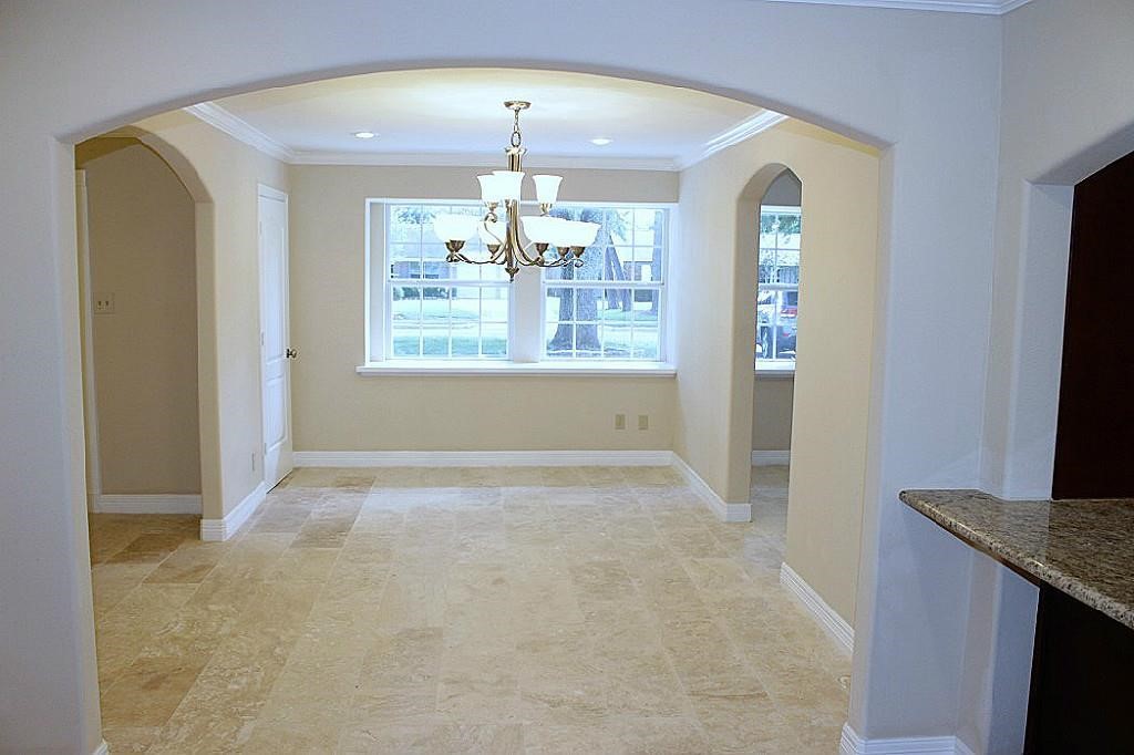5738 Willowbend Boulevard Houston, TX 77096 - Photo 5 of 28 an empty room with chandelier fan and windows