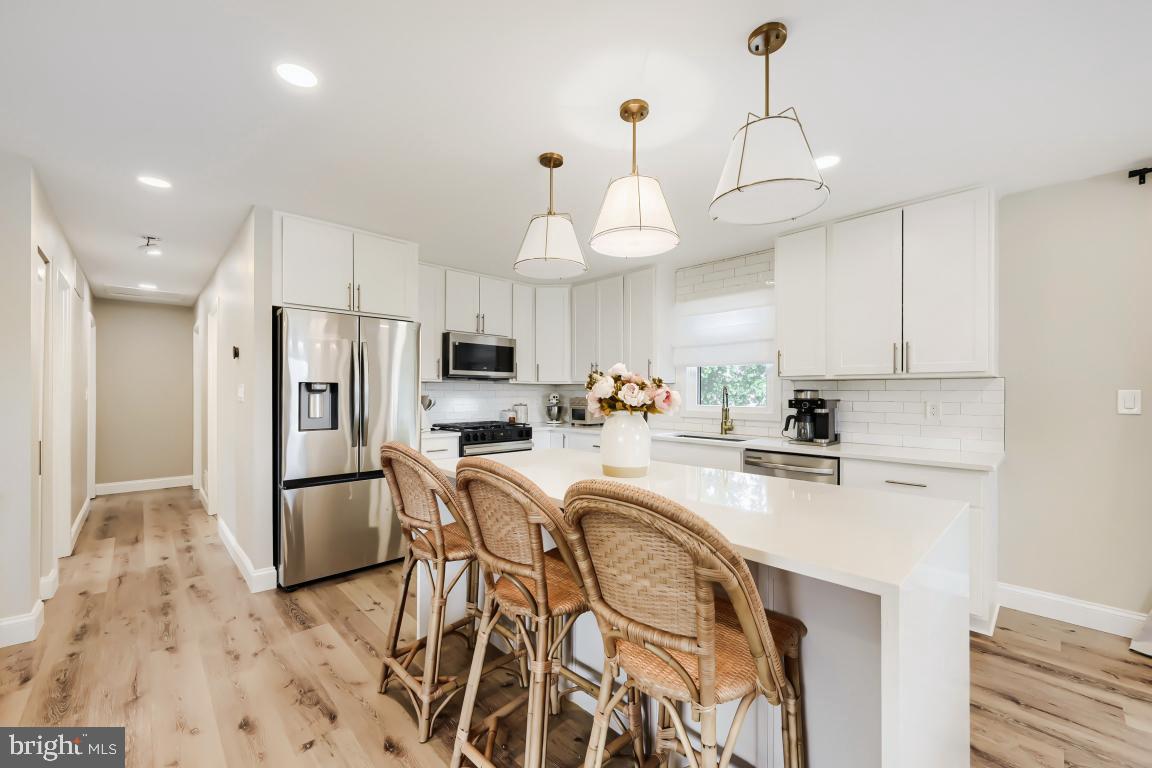 600 East Macphail Road Bel Air, MD 21014 - Photo 13 of 37 a kitchen with stainless steel appliances a refrigerator a stove a sink dishwasher a oven with white cabinets and wooden floor