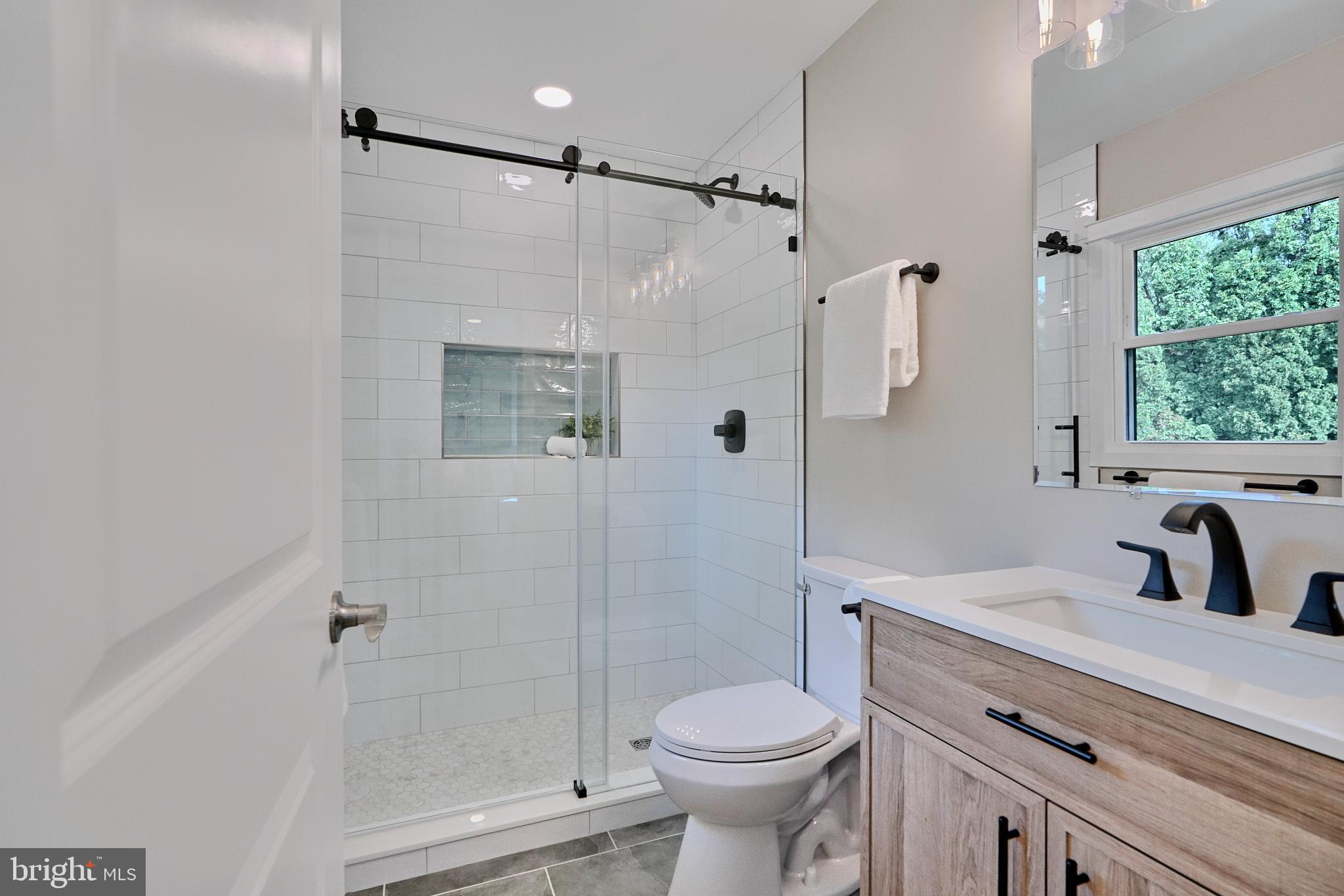 600 East Macphail Road Bel Air, MD 21014 - Photo 20 of 37 a bathroom with a shower sink vanity mirror and toilet