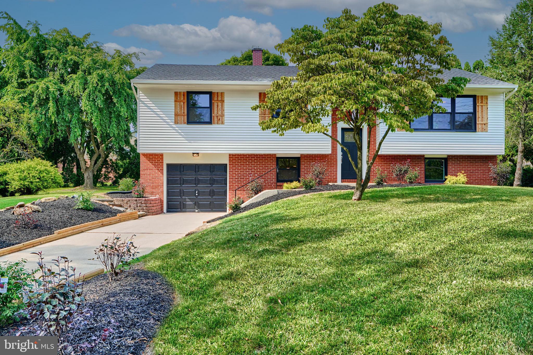 600 East Macphail Road Bel Air, MD 21014 - Photo 2 of 37 a front view of a house with a yard and garage