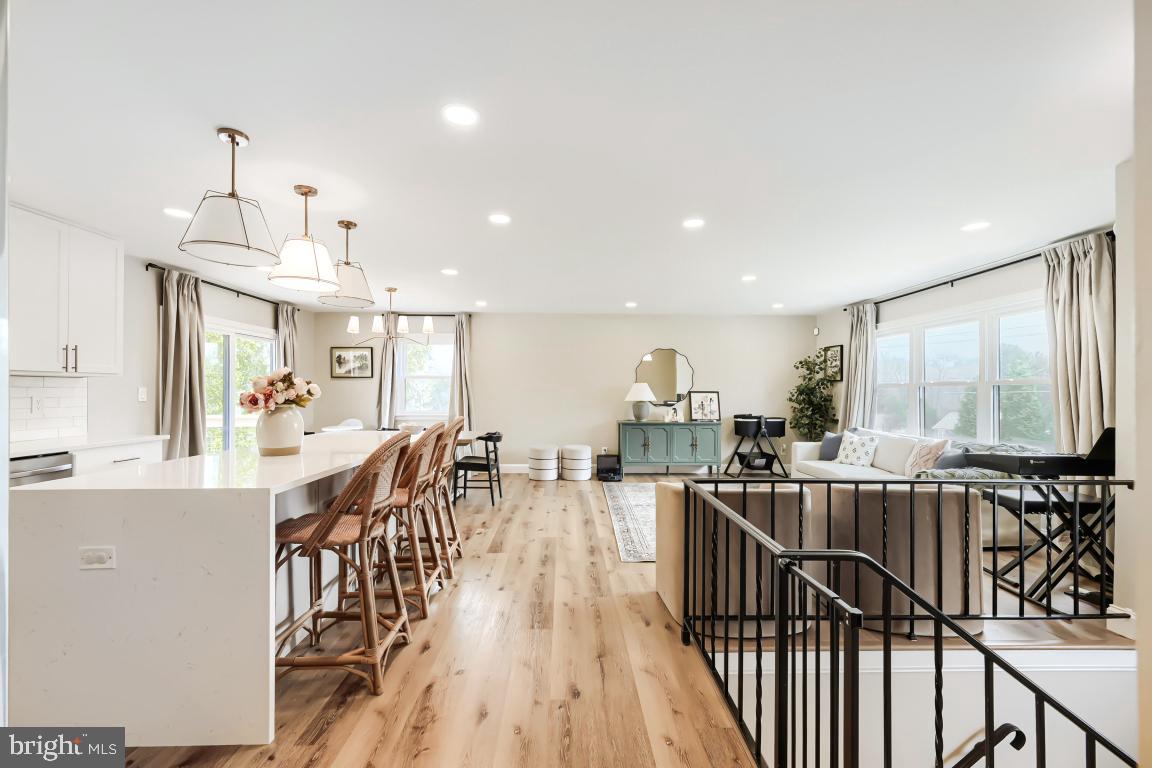 600 East Macphail Road Bel Air, MD 21014 - Photo 5 of 37 a view of a dining room and livingroom with furniture wooden floor a chandelier