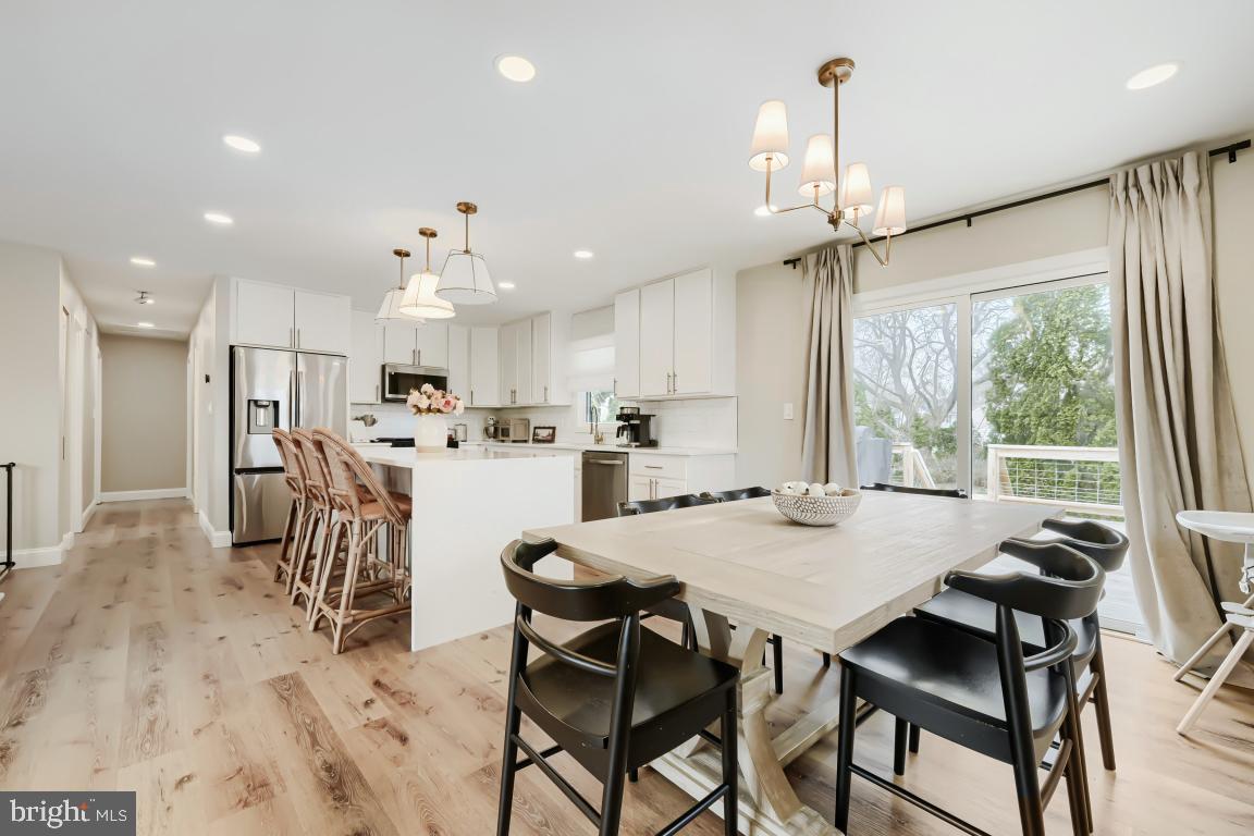 600 East Macphail Road Bel Air, MD 21014 - Photo 7 of 37 a view of a dining room and livingroom with furniture wooden floor a chandelier