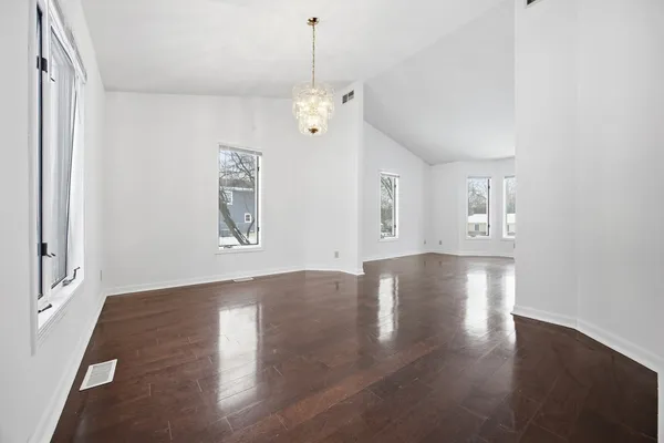 a view of a livingroom with wooden floor and window