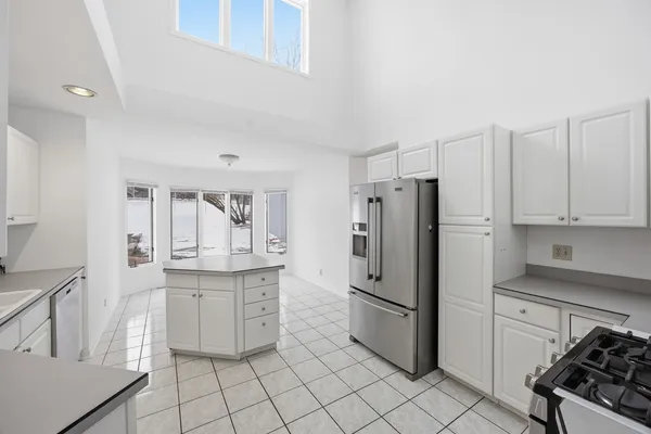a kitchen with granite countertop a sink stove and refrigerator