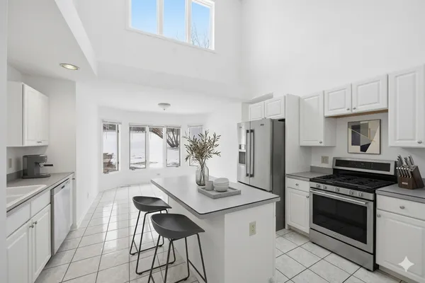 a kitchen with stainless steel appliances a refrigerator and a sink