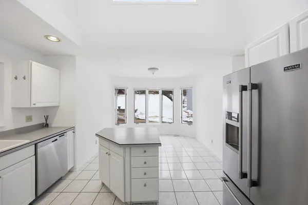 a kitchen with a refrigerator a stove a sink and a center island