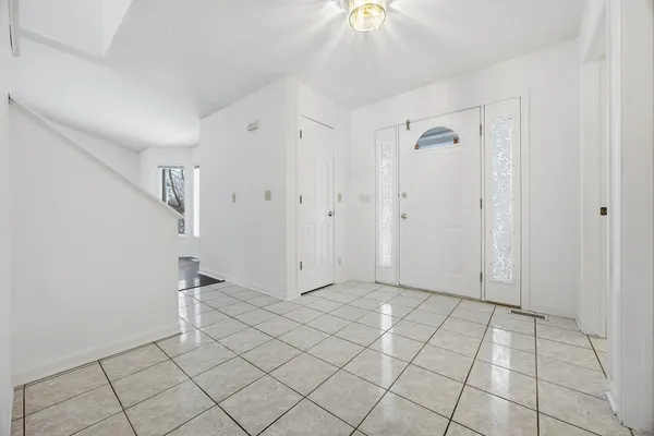 a bathroom with a shower a toilet a sink and mirror