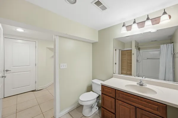 a front view of a house with a yard covered with snow
