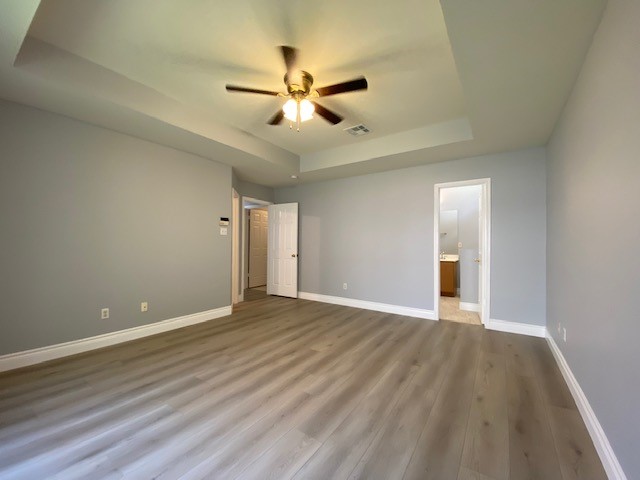 1512 Lorson Loop Round Rock, TX 78665 - Photo 22 of 29 a view of an empty room with wooden floor and a ceiling fan