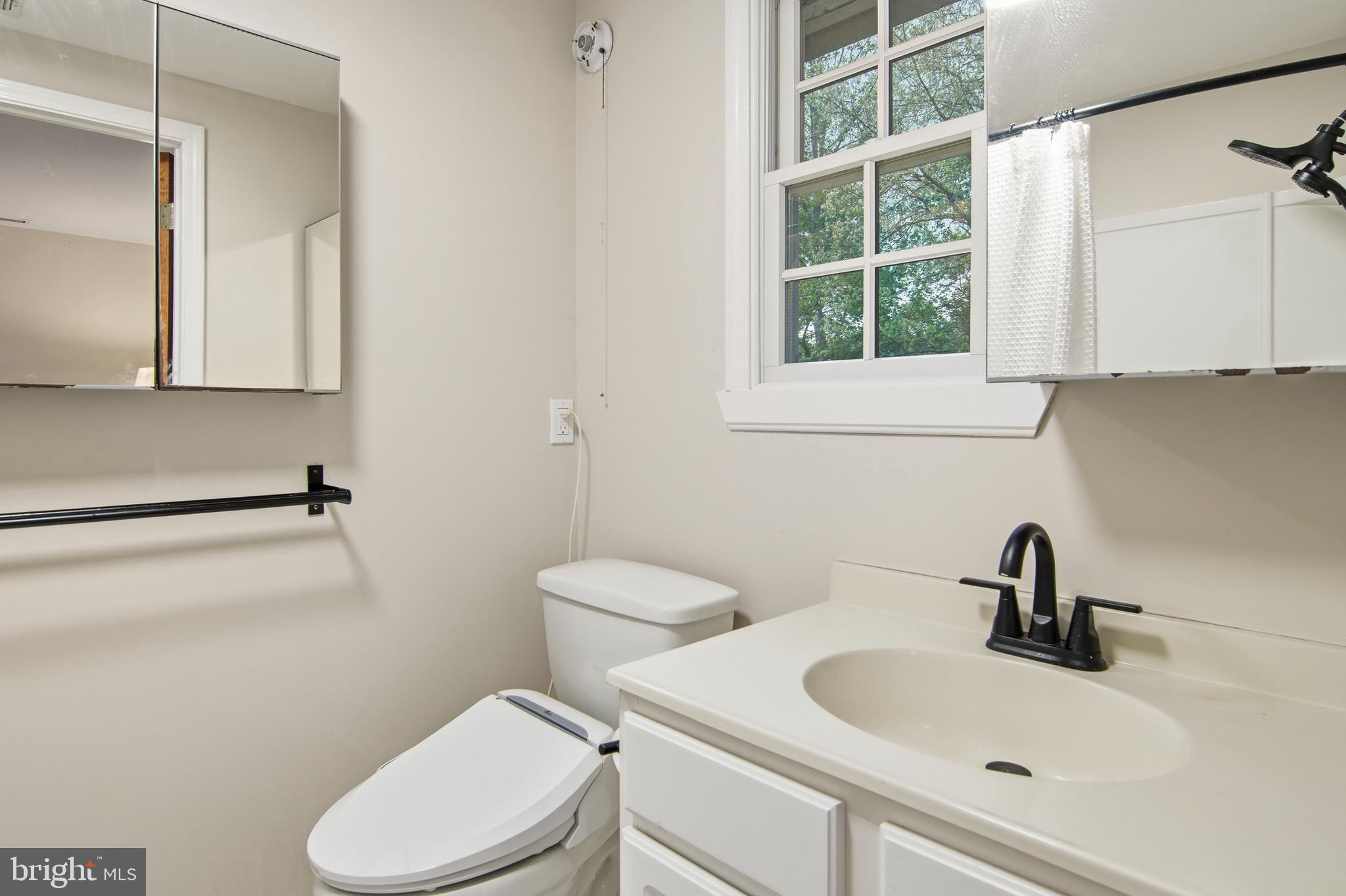 18708 York Road Parkton, MD 21120 - Photo 23 of 59 a bathroom with a sink a toilet and a mirror