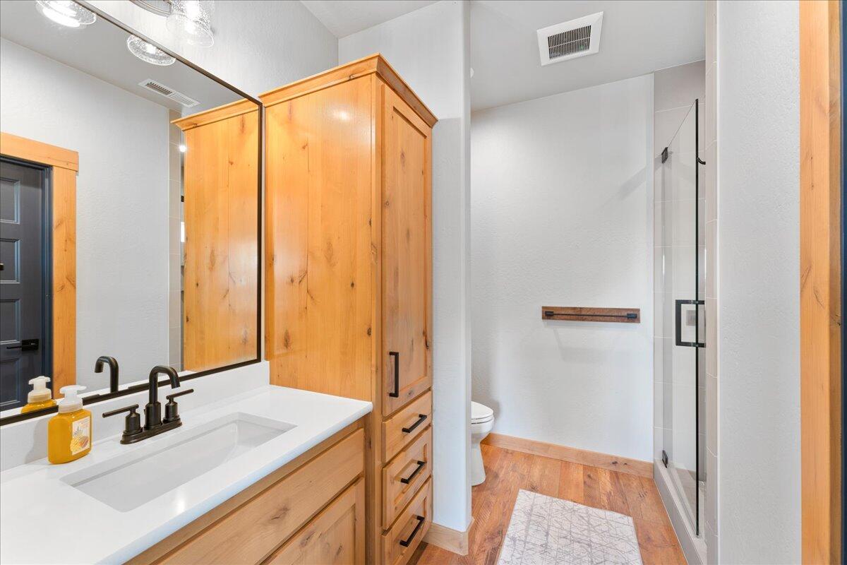 2220 Butte Falls Highway Eagle Point, OR 97524 - Photo 40 of 69 a bathroom with a double vanity sink and mirror