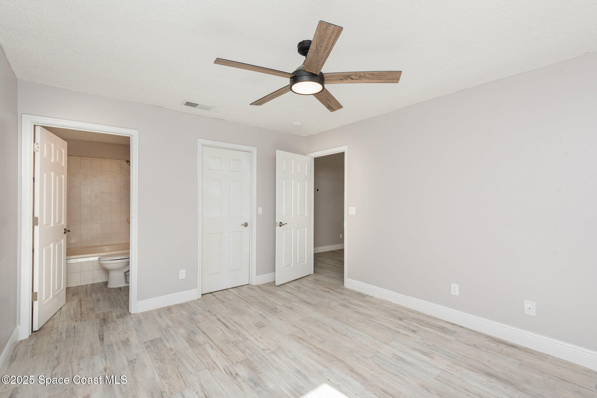 1045 Jacaranda Circle Rockledge, FL 32955 - Photo 13 of 32 a view of an empty room and wooden floor