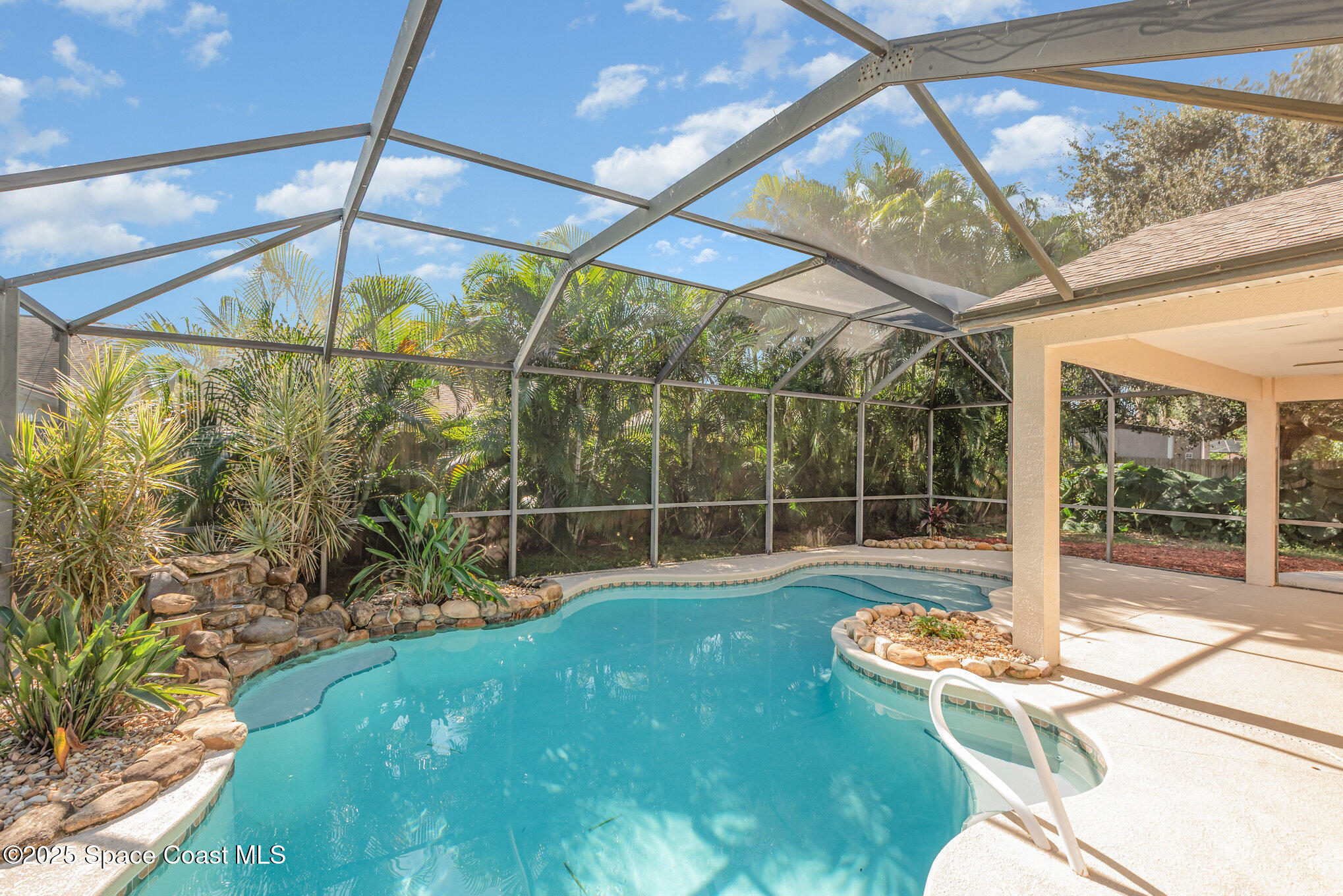 1045 Jacaranda Circle Rockledge, FL 32955 - Photo 24 of 32 a backyard of a house with table and chairs