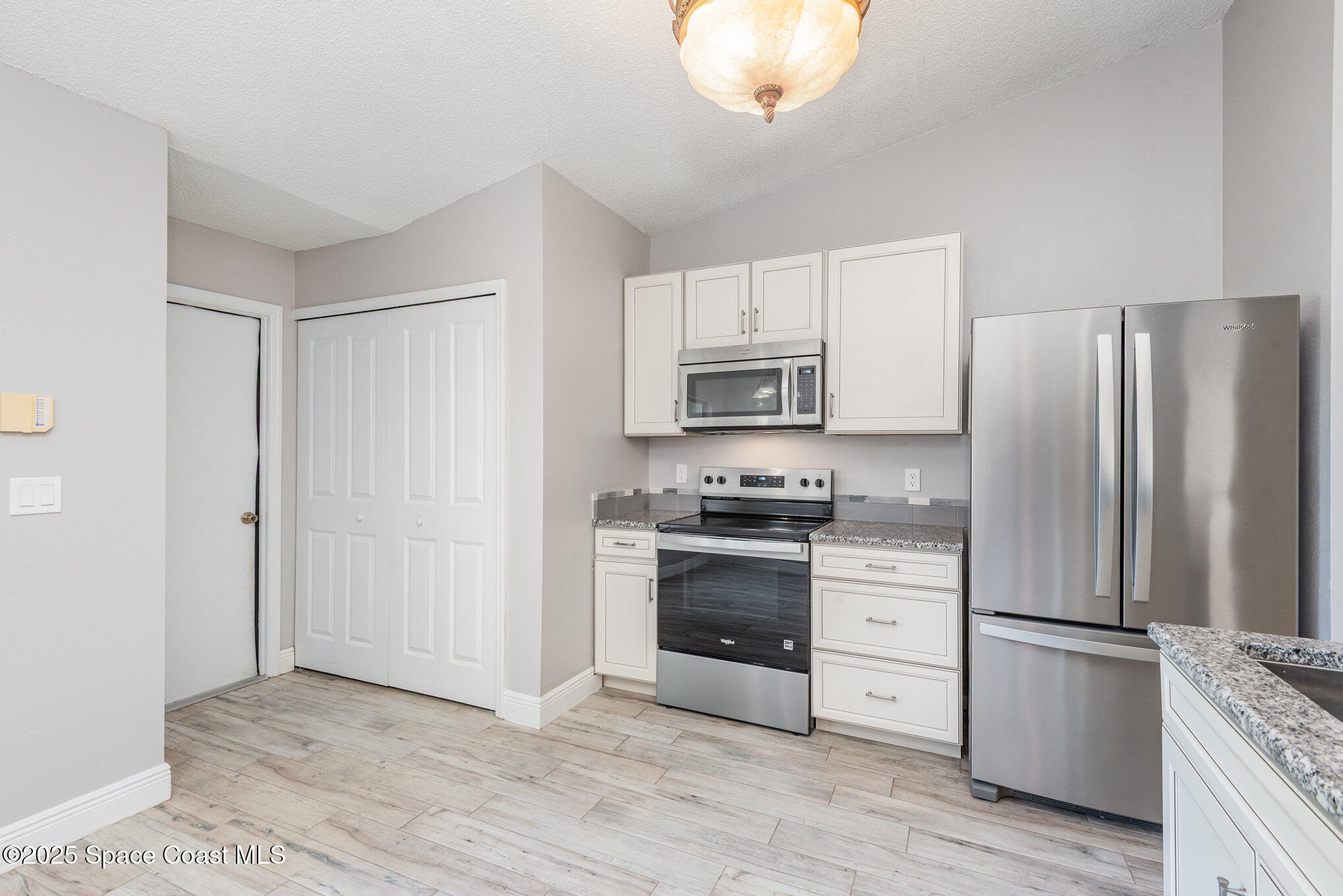 1045 Jacaranda Circle Rockledge, FL 32955 - Photo 10 of 32 a kitchen with stainless steel appliances a refrigerator stove and microwave