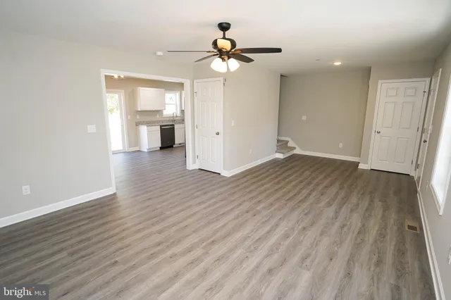 a view of an empty room and wooden floor