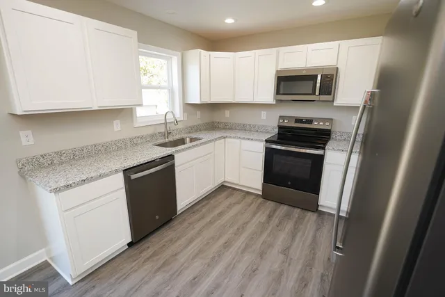 a kitchen with a sink stove and microwave