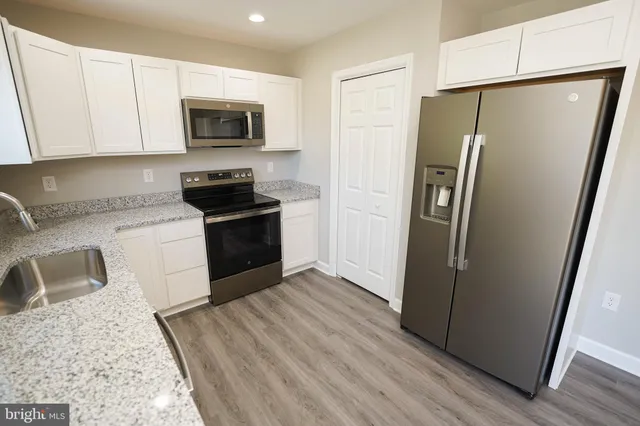 a kitchen with a refrigerator stove and sink