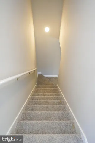 a view of staircase with white walls