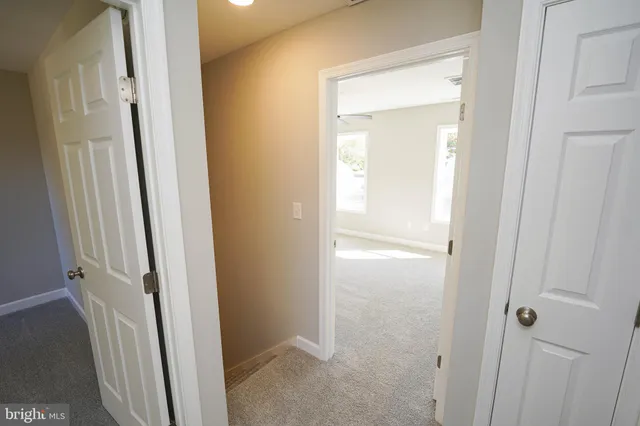 a view of a bathroom from a corridor