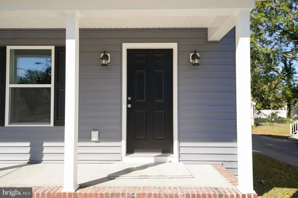 a view of a door of the house and front view of a house