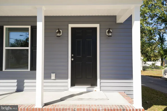 a view of a door of the house and front view of a house