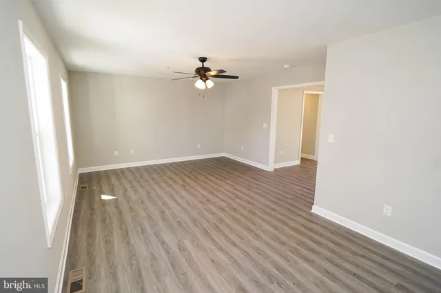 wooden floor in an empty room with a window