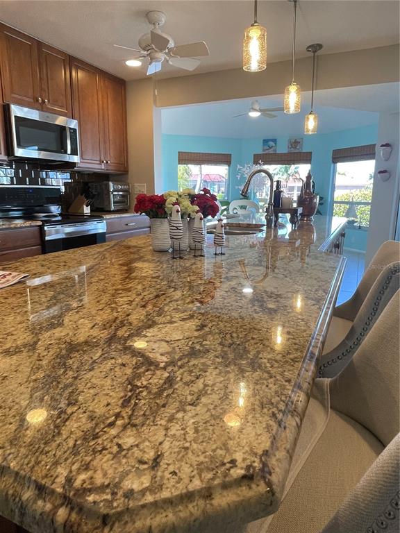3433 Nighthawk Court Punta Gorda, FL 33950 - Photo 12 of 21 a kitchen with sink refrigerator dining table and chairs