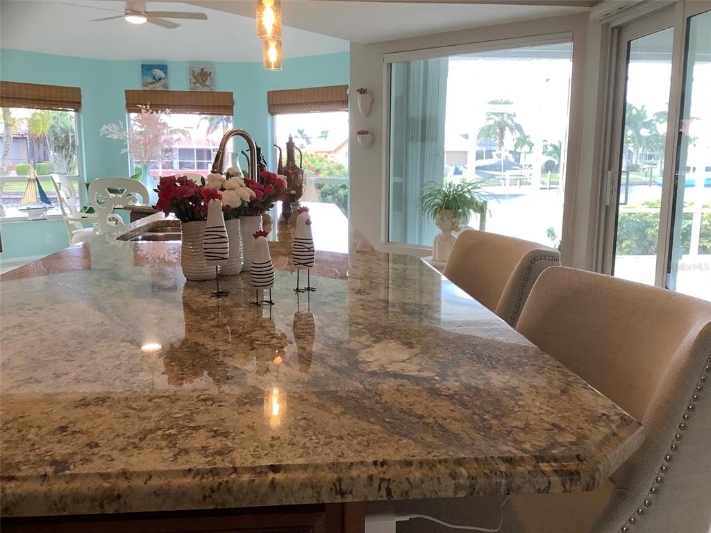 3433 Nighthawk Court Punta Gorda, FL 33950 - Photo 14 of 21 a living room filled with furniture hardwood floor and a floor to ceiling window