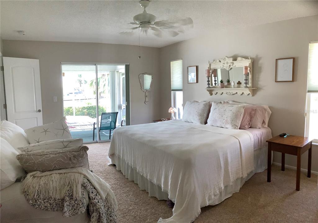 3433 Nighthawk Court Punta Gorda, FL 33950 - Photo 16 of 21 a spacious bedroom with a bed and a couch