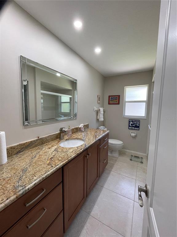 3433 Nighthawk Court Punta Gorda, FL 33950 - Photo 19 of 21 a bathroom with a granite countertop sink mirror and cabinets