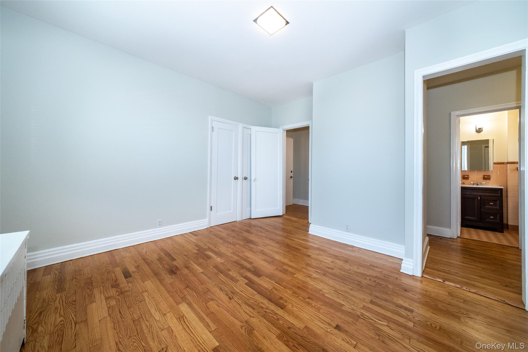 7 Alpha Place, Unit FIRST New Rochelle, NY 10805 - Photo 11 of 25 Unfurnished bedroom featuring wood finished floors