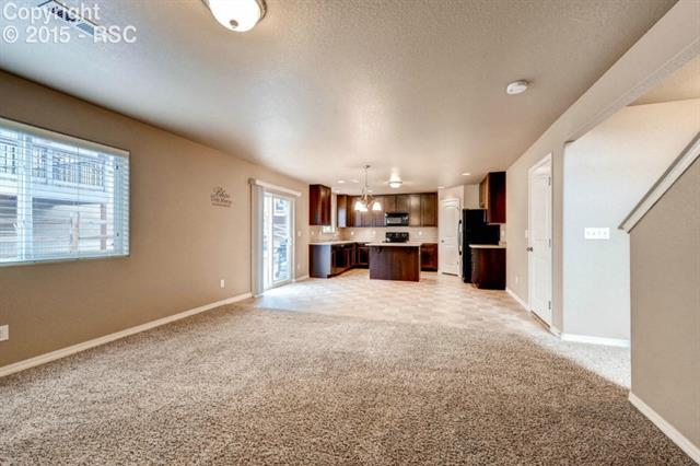 944 Diamond Rim Drive Colorado Springs, CO 80921 - Photo 15 of 28 View from the family room into kitchen and dining area demonstrates the open great room feeling.
