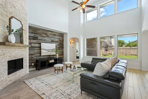 a living room with furniture a fireplace and wooden floor